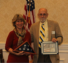 First Vice President Howell Sassar presents Tracy Gillespie with tokens of appreciation for speaking at the monthly chapter meeting